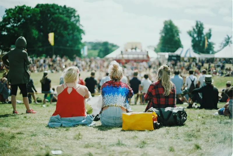 People relaxing on the grass at a summer gathering