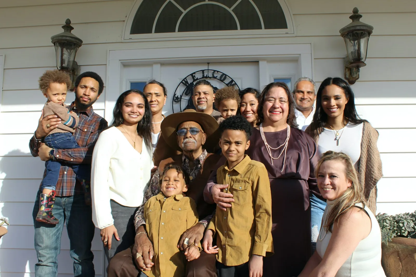 A large family group gathered on a porch